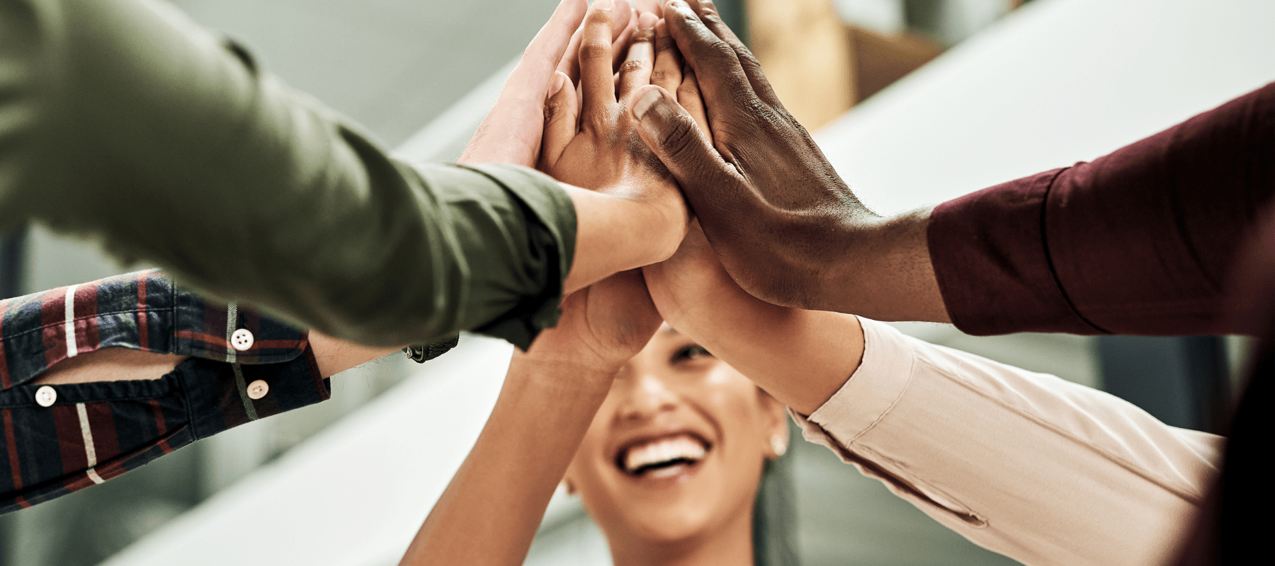 BioFusion Peptides team members joining hands in a unified high-five, symbolizing teamwork and collaboration