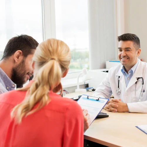Doctor consulting with a couple, discussing the differences between peptide therapy and traditional treatments
