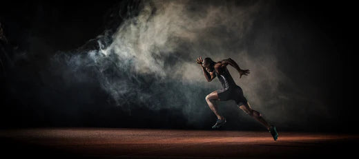 Athlete sprinting with a cloud of dust in the background, symbolizing the natural health-boosting power of peptides