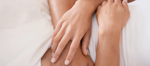 Close-up of hands resting on a person's arm, symbolizing the role of peptides in hormone regulation and overall well-being