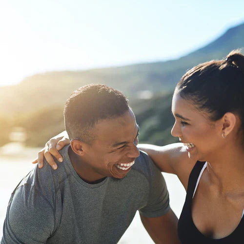 Happy couple exercising outdoors, representing the health benefits of peptides for enhancing well-being