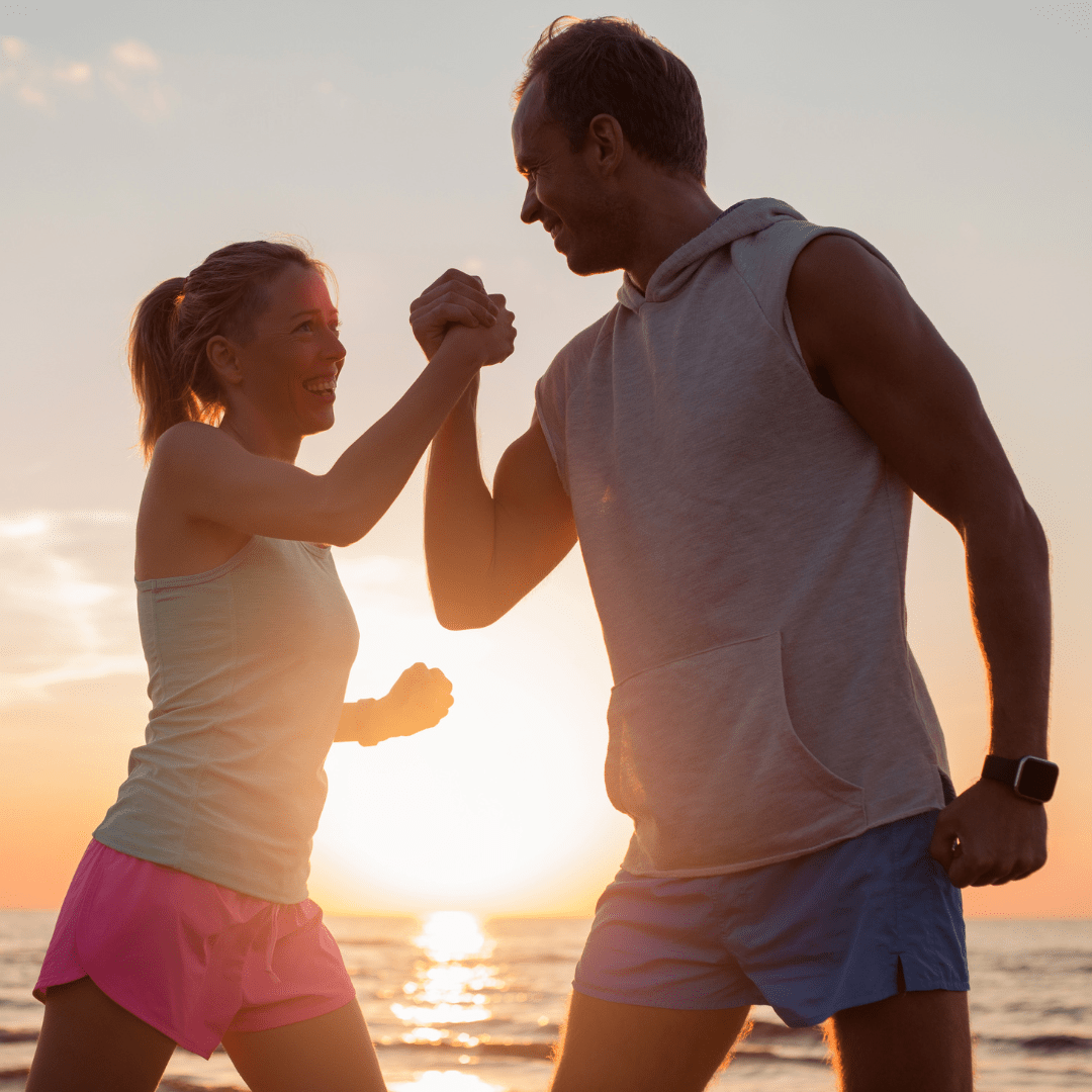Two people celebrating wellness and vitality at sunset, symbolizing the journey of optimal health with BioFusion Peptides Membership