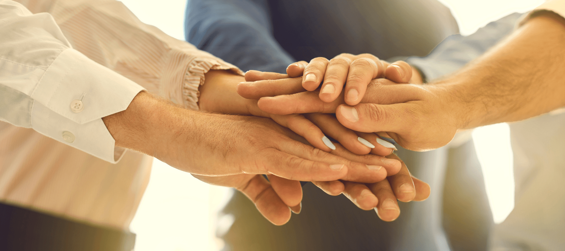 Hands stacked together symbolizing unity and support in the BioFusion Peptides membership community