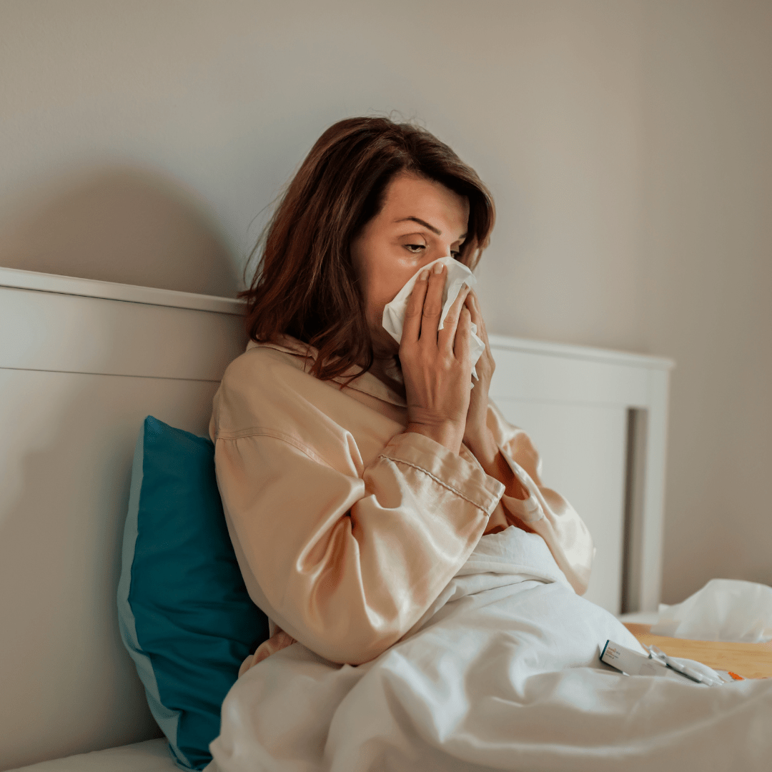 Woman covering her nose while sick, highlighting immune health support with BioFusion Peptides