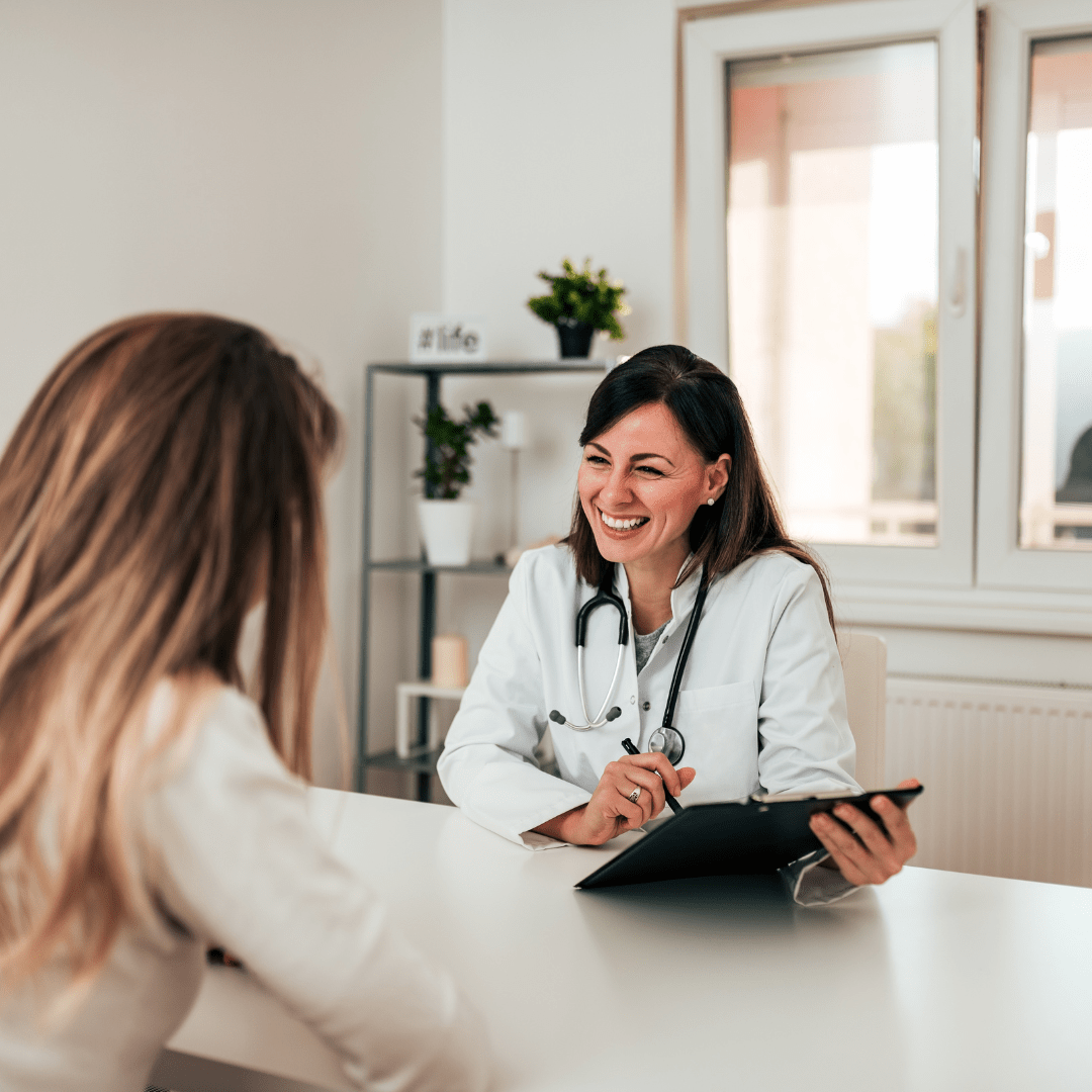 Doctor smiling and discussing with a patient, symbolizing professional and personalized guidance support