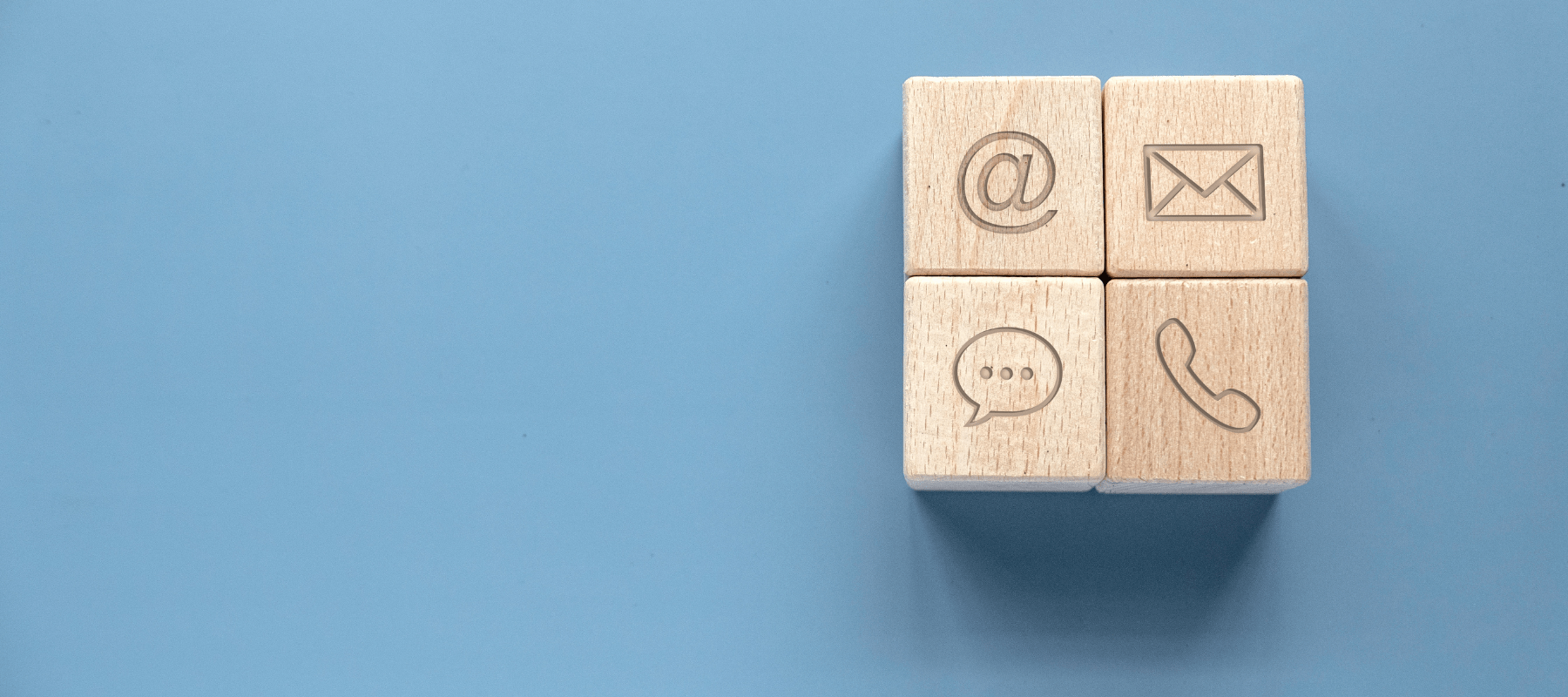 Wooden blocks with contact icons representing email, phone, and messaging for BioFusion Peptides' Contact Us page
